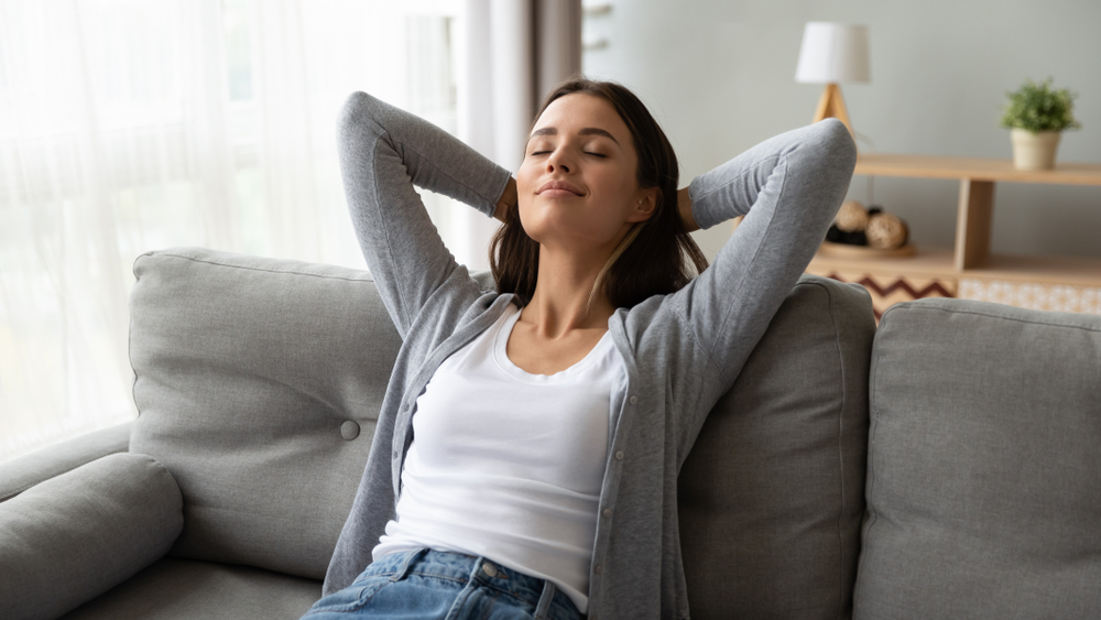 Relaxed woman breathing quality air in her house - 6 Health Benefits of Quality Home Insulation