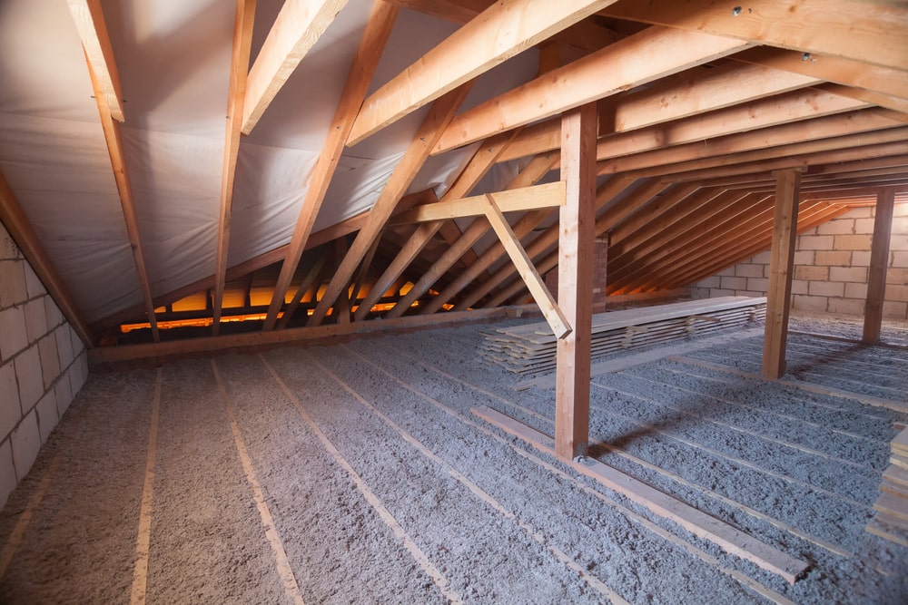 Attic of a building with wooden beams of a roof structure - The Ins and Outs of Home Insulation: Why It Matters for New Orleans