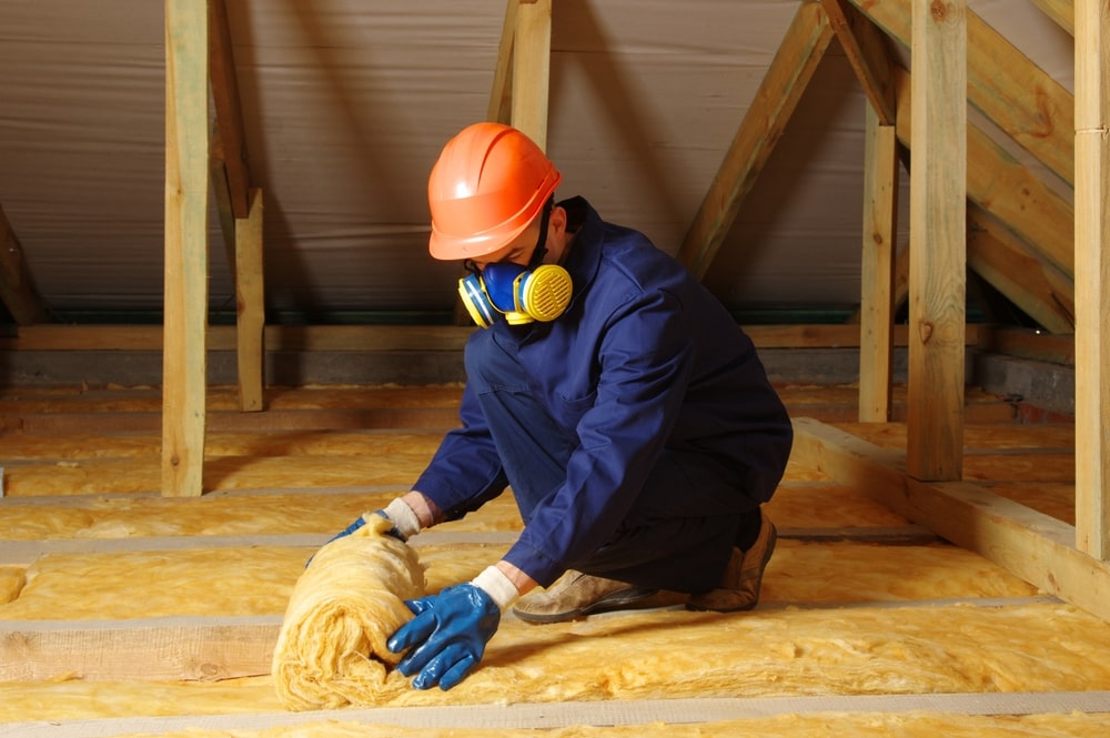 Worker insulate the attic with mineral wool - Why Insulation Matters: Comfort, Efficiency, and Sustainability