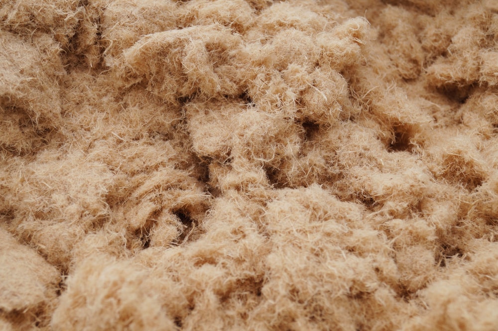 Close-up texture of blown-in natural wood fiber insulation used for thermal insulation in New Orleans homes