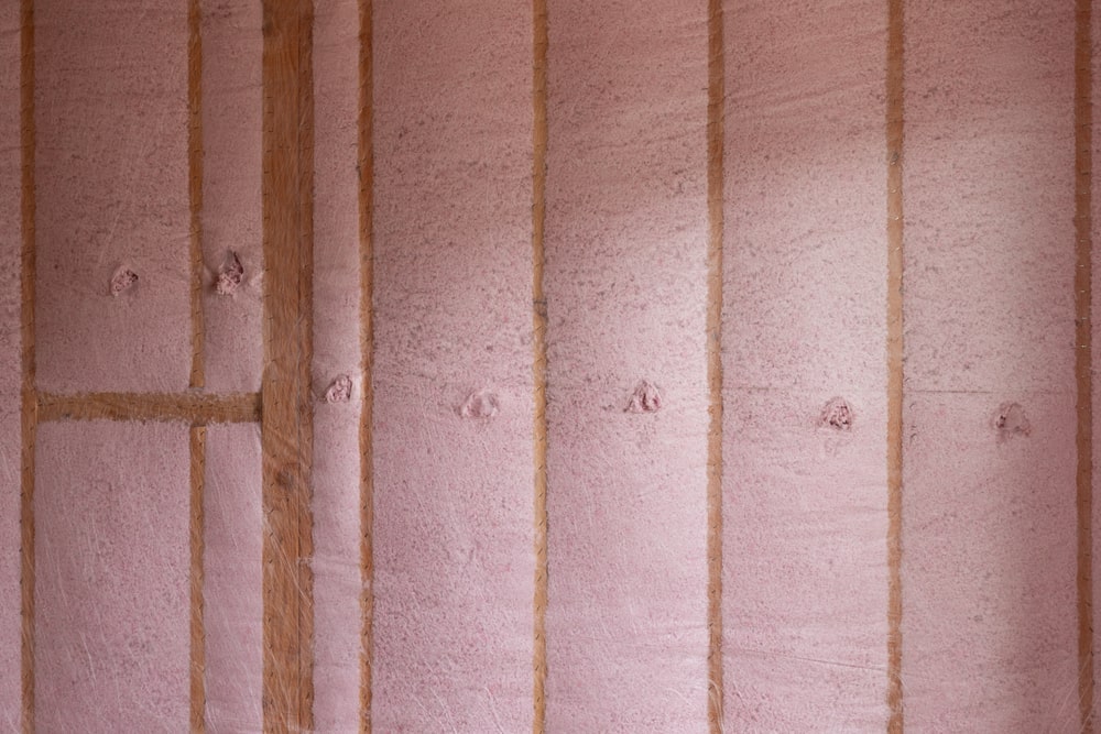 Blown-in fiberglass insulation being installed in a new home