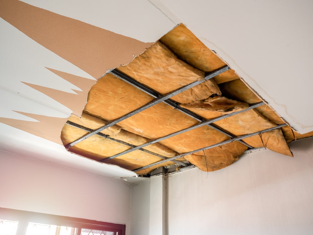 Damaged Ceiling - White Ceiling Ruined with Old Yellow Thermal Insulation Foam