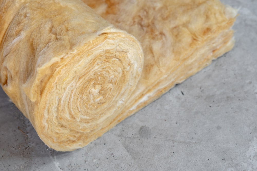 Mineral wool insulation laid out on the attic floor with space for copy inside a home under construction in New Orleans.